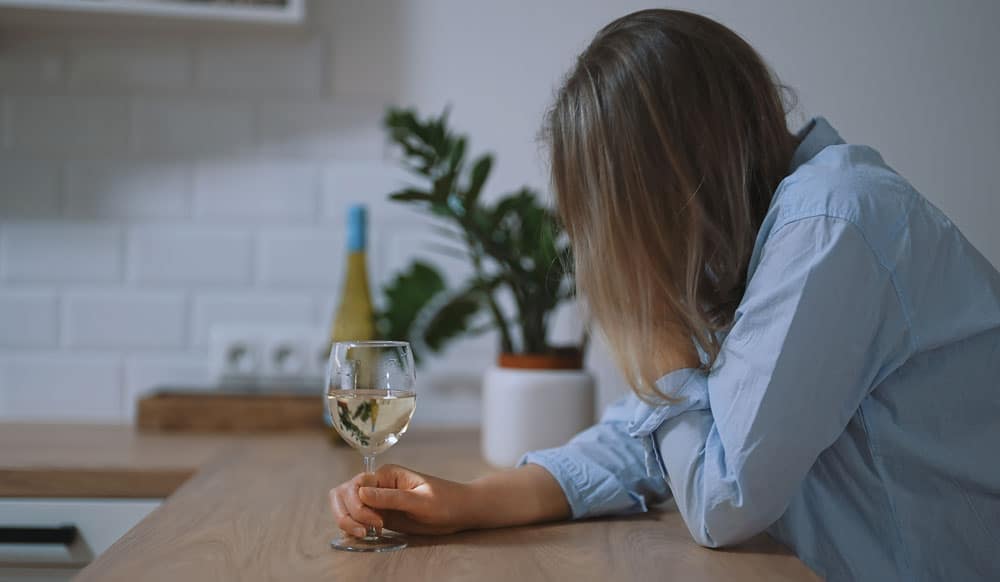 depressed woman drinking alone