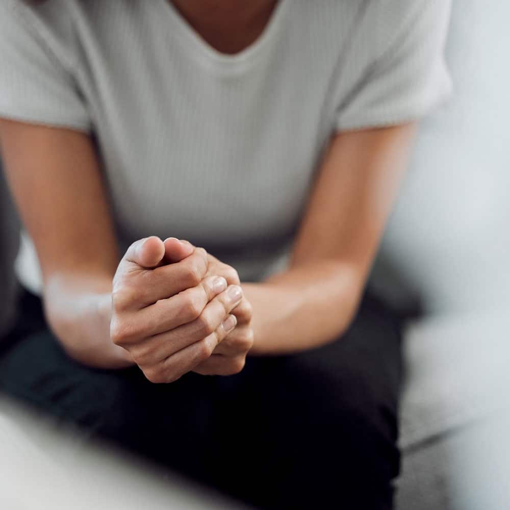 close up of woman with hands in her lap