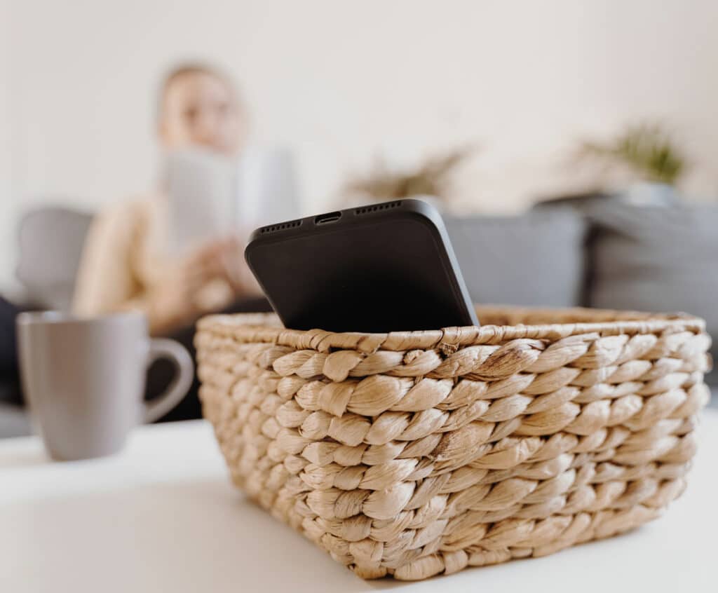woman taking a break from phone and putting it in basket