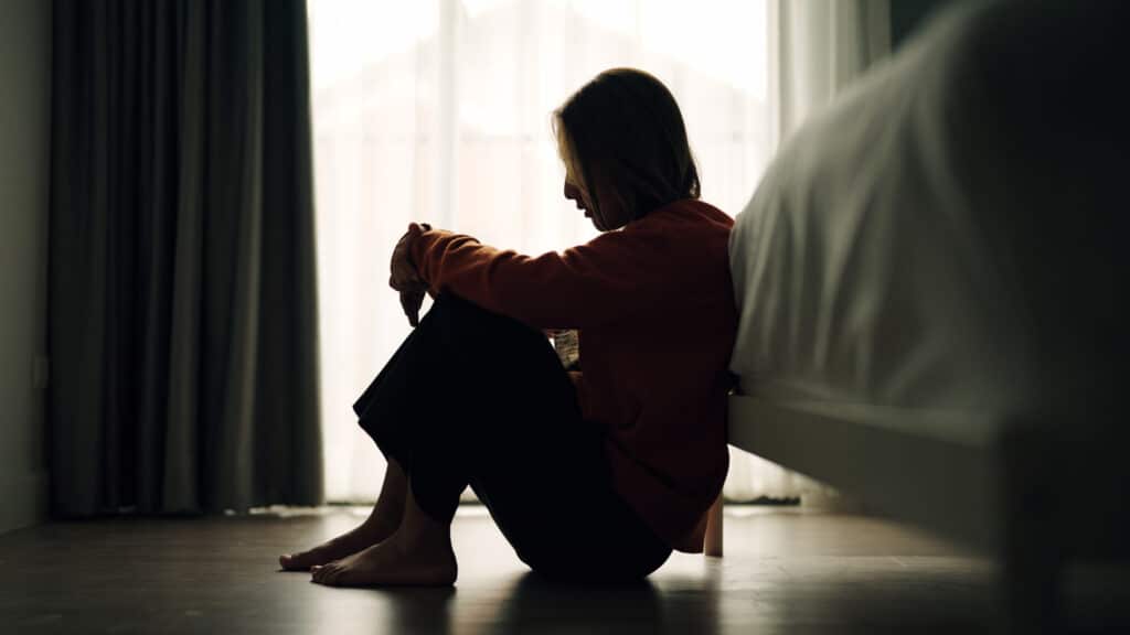 In silhouette of woman sad depression in bedroom.