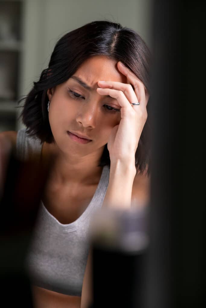 Young Asian woman feeling sad tired and worried suffering depression in mental health.