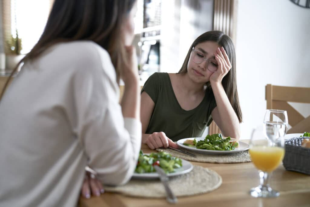 Caucasian woman support her daughter with arfid eating disorder
